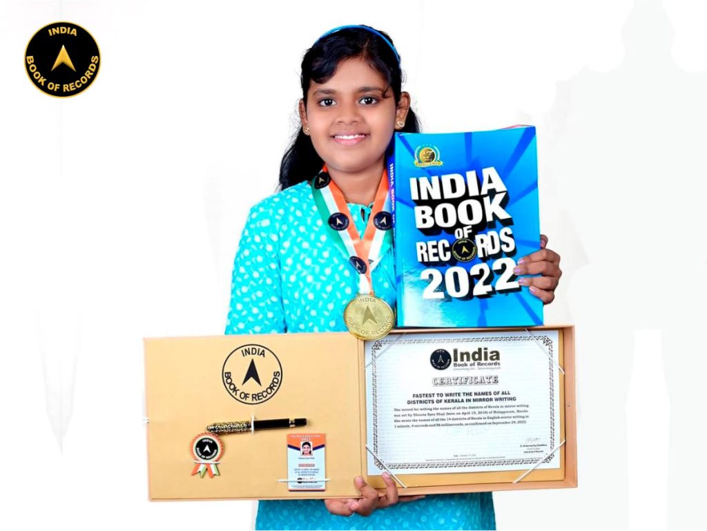 Fastest child to write the names of all districts of Kerala in mirror