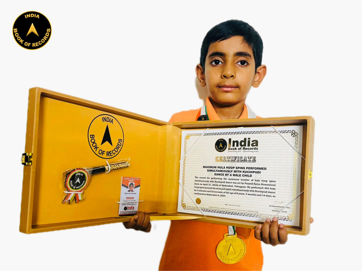 Maximum hula hoop spins performed simultaneously with Kuchipudi dance by a male child