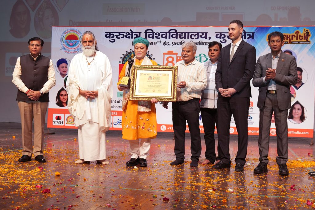 (L–R): Justice Lalit Batra, Swami Shri Gyananand Ji Maharaj, Prof. Dr. Chu Bao Que, Dharmender Dangi, Vikas Sharma, Walid Hasbi, and Dr. Biswaroop Roy Chowdhury at the 8th Haryana International Film Festival at Kurukshetra University