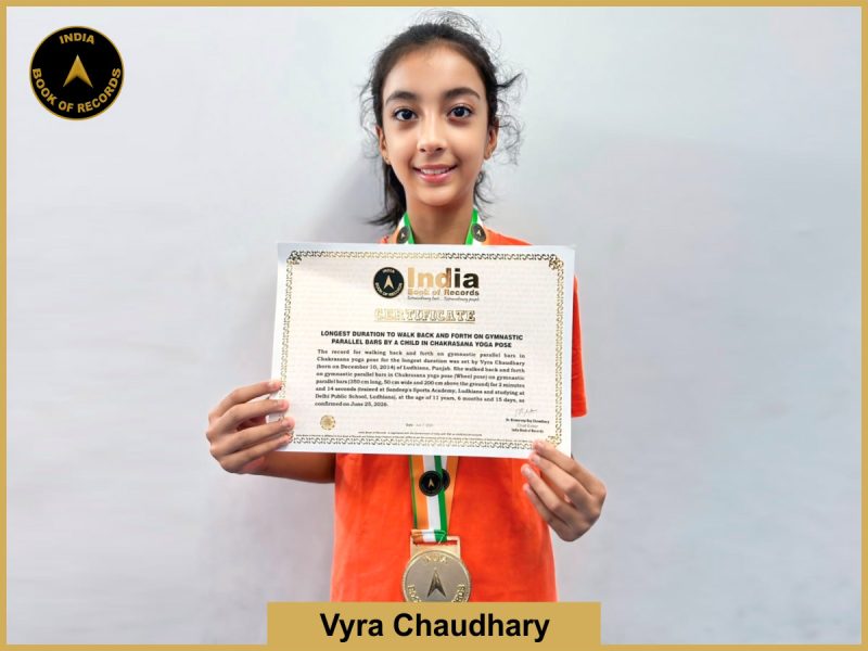 Image of Vyra Chaudhary, Longest duration to walk back and forth on gymnastic parallel bars by a child in Chakrasana yoga pose.